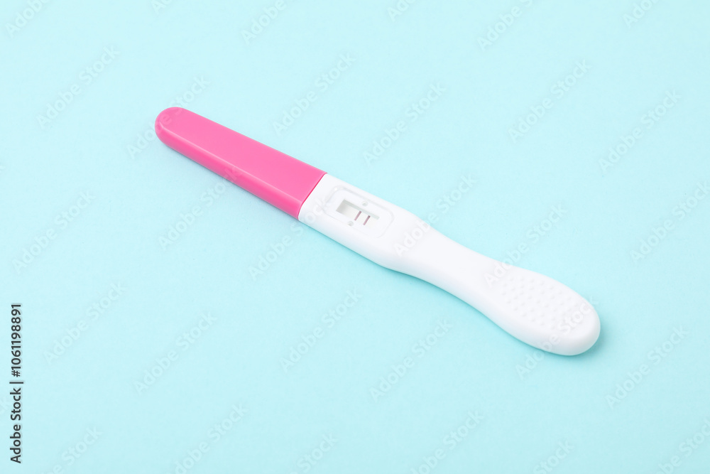 One pregnancy test on light blue background, closeup One pregnancy test on light blue background, closeup
