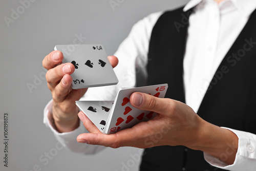 Bild auf Leinwand Professional croupier shuffling cards on grey background, closeup