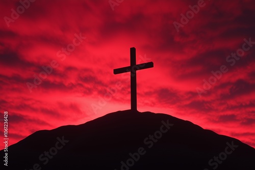 A wooden cross silhouette against a dramatic red sunset sky.