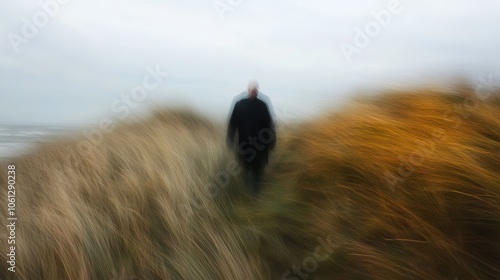 An old man dressed in black walked slowly on the grass dunes, enjoying the bright and clear sky. Reflecting peaceful moments in nature while evoking nostalgia and reflection on the journey of life.