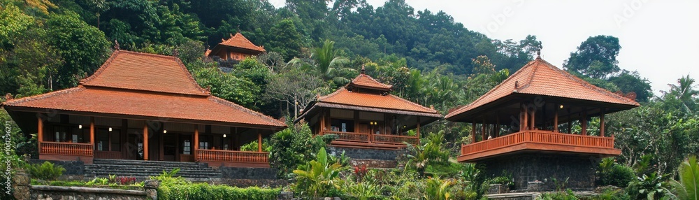 Scenic view of traditional-style buildings surrounded by lush greenery. Scenic view of traditional-style buildings surrounded by lush greenery.