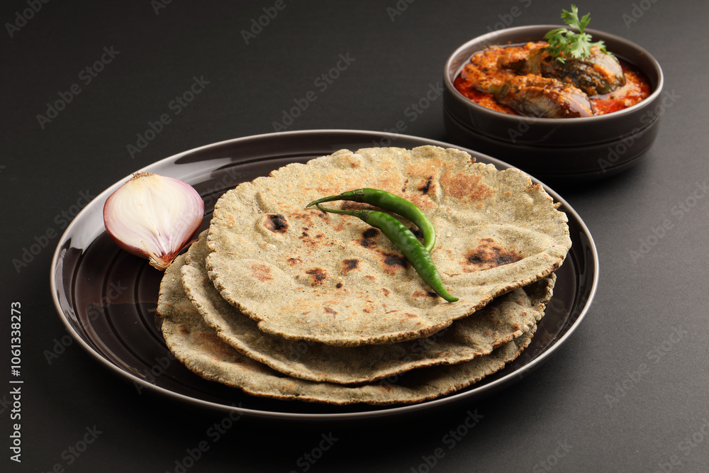 Roti or millet flat bread.Made with chana ,caun, green moong , udad ,ragi , Jowar farmer's lunch Indian bread with Brinjal curry Roti or millet flat bread.Made with chana ,caun, green moong , udad ,ragi , Jowar farmer's lunch Indian bread with Brinjal curry