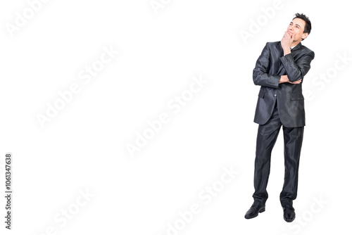 Dreamy businessman touching chin and thinking in studio