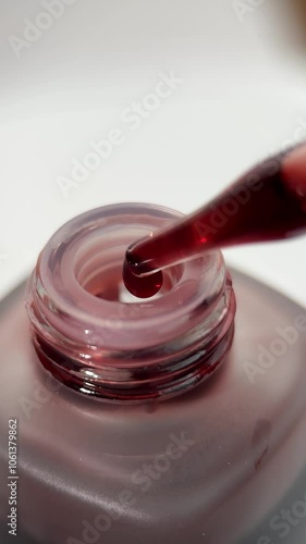 Skincare red serum video product microlens detail texture drips & bubble liquids serum red maroon from bottle photo