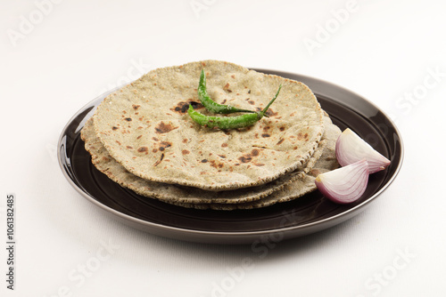 Indian traditional multigrain roti or millet flat bread.Made with chana ,caun, green moong , udad ,ragi , Jowar farmer's lunch Indian bread with chickpea powder curry photo