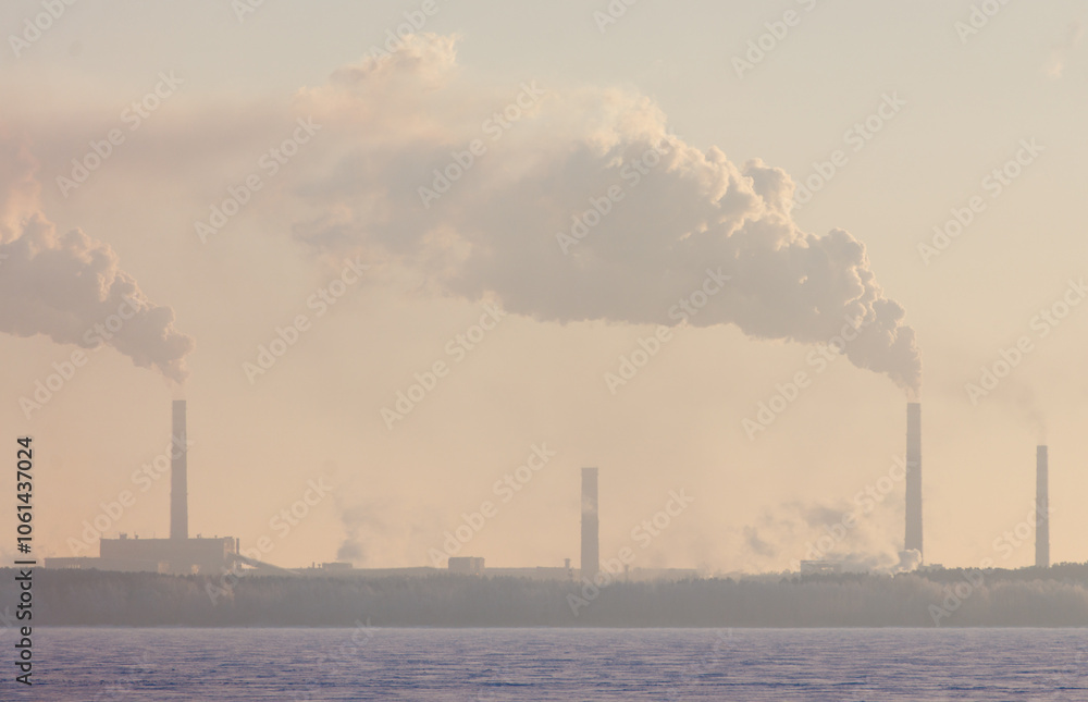 A large industrial plant is emitting smoke into the air A large industrial plant is emitting smoke into the air