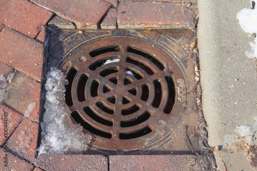 metal drain on the cobbled street photo