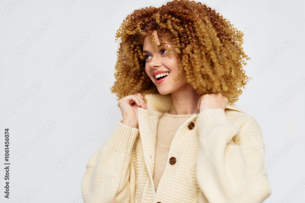 Smiling woman with curly hair in a cozy cardigan against a light background, exuding warmth and joy, perfect for fashion and lifestyle themes Smiling woman with curly hair in a cozy cardigan against a light background, exuding warmth and joy, perfect for fashion and lifestyle themes