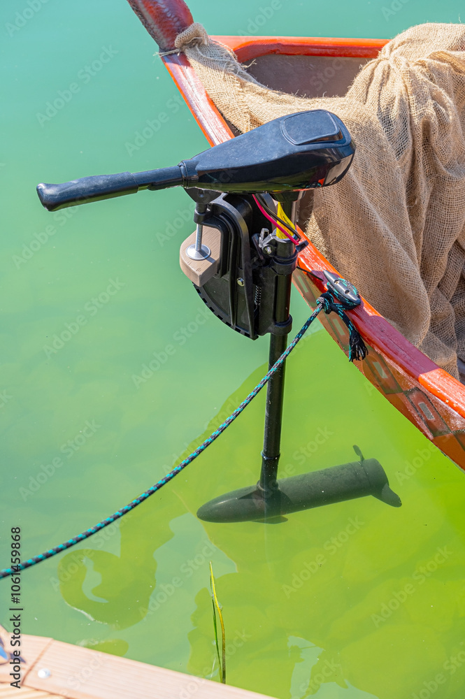 The small electric motor on the boat The small electric motor on the boat