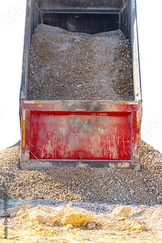 A truck unloads crushed stone at a construction site photo