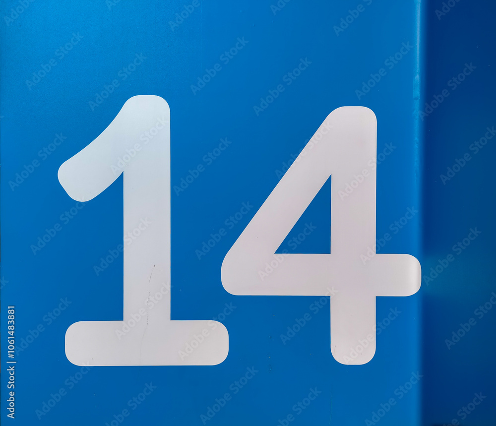 number fourteen, 14 in number on a blue surface with a dark side number fourteen, 14 in number on a blue surface with a dark side