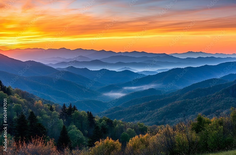 panoramic view of the majestic mountains under an orange and blue sky panoramic view of the majestic mountains under an orange and blue sky