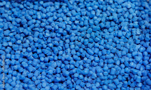 The pile of blue pellets materials for plastic injection process. The raw material from petrochemical products. photo