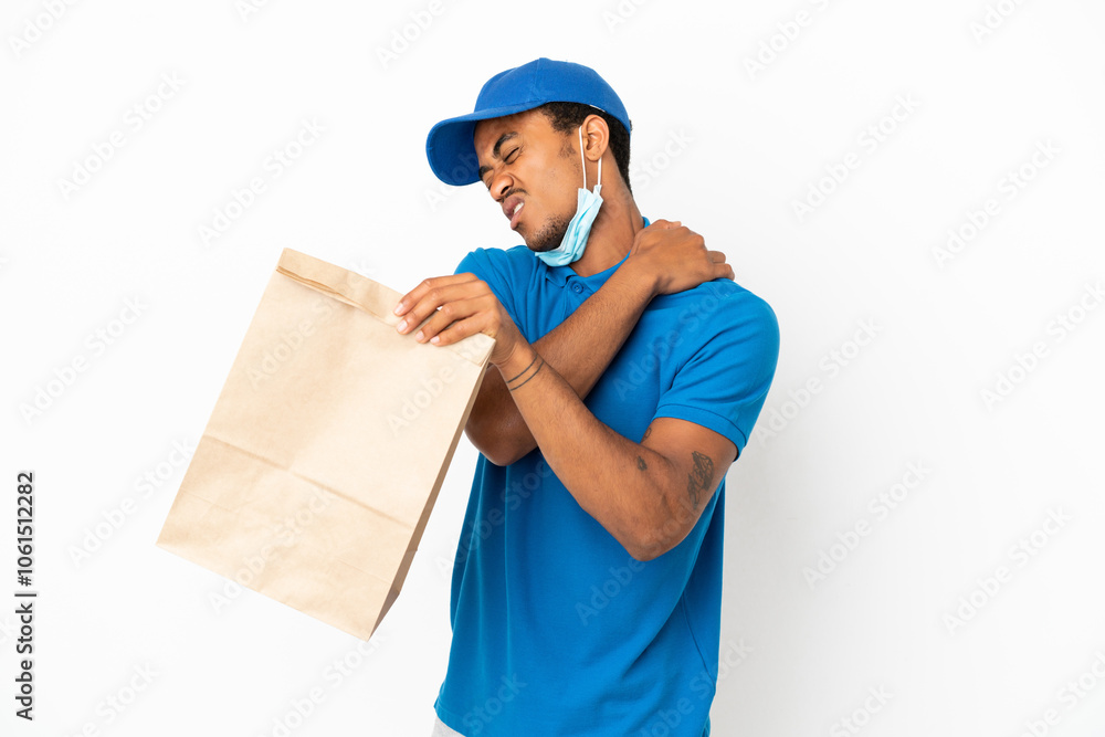 African American man taking a bag of takeaway food isolated on white background suffering from pain in shoulder for having made an effort African American man taking a bag of takeaway food isolated on white background suffering from pain in shoulder for having made an effort