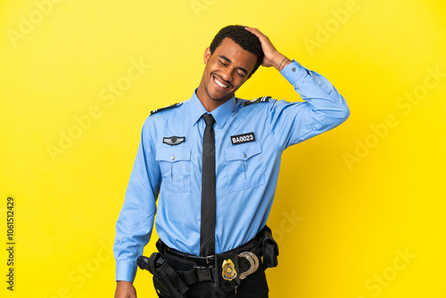 African American police man over isolated yellow background smiling a lot