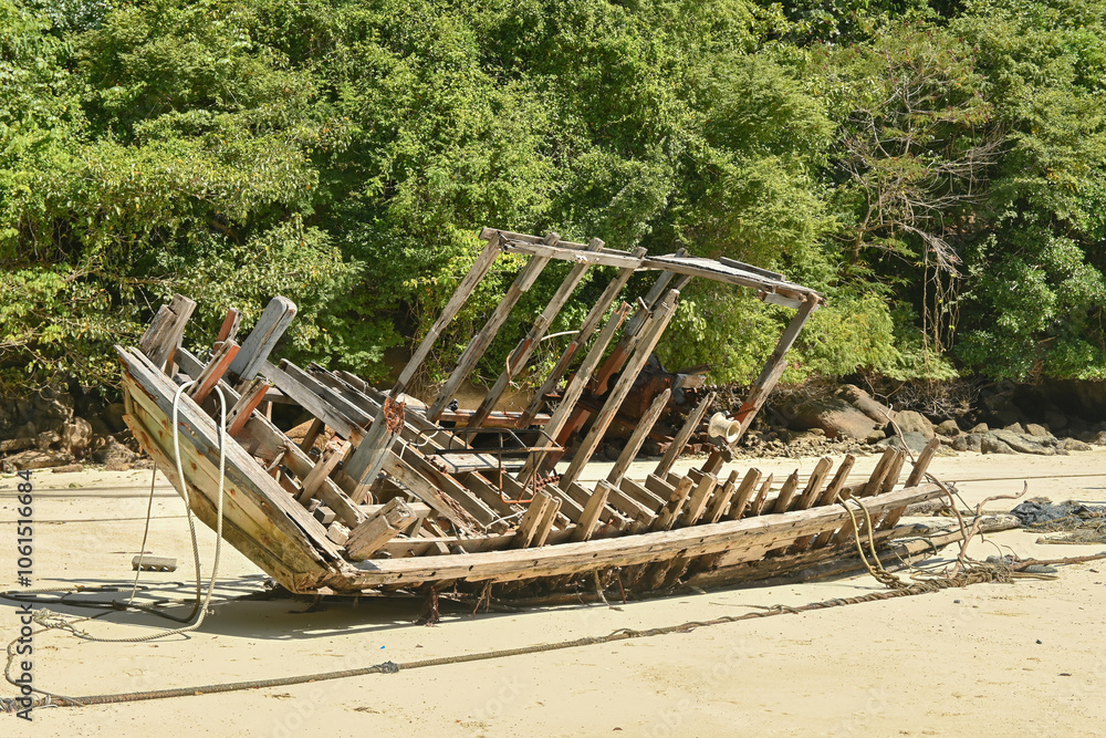 The abandoned wooden of shipwrecked structure that stranded on the peaceful beach at the Surin Islands in Thailand. The abandoned wooden of shipwrecked structure that stranded on the peaceful beach at the Surin Islands in Thailand.