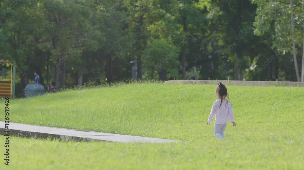 Adorable little girl enjoy walk and run on green meadow grass outdorr recreation fell free Adorable little girl enjoy walk and run on green meadow grass outdorr recreation fell free