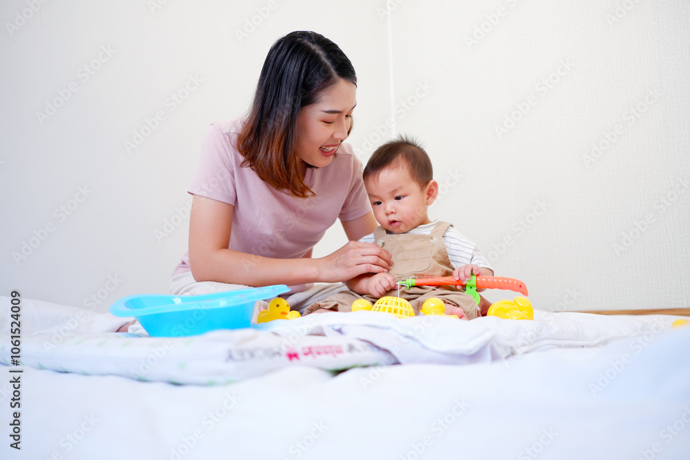 Mother and baby smiling and playing happily. Mother and baby smiling and playing happily.
