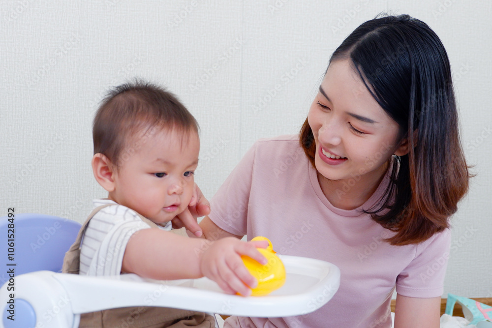 Cute mother and little baby sitting and playing on the bed smiling and happy. Cute mother and little baby sitting and playing on the bed smiling and happy.