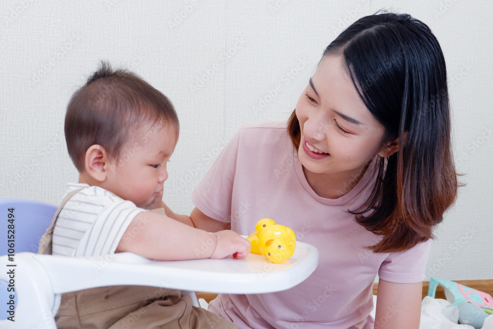 Cute mother and little baby sitting and playing on the bed smiling and happy. Cute mother and little baby sitting and playing on the bed smiling and happy.