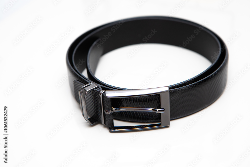 Black leather belt with metal buckle on white background Black leather belt with metal buckle on white background