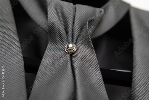 Elegant gray cravat with diamond brooch on a mannequin
