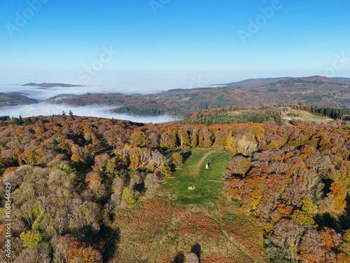 Aerial view of Mont Beuvray in the Morvan in Burgundy, France, with the forest in autumn colours and clouds in the valleys photo