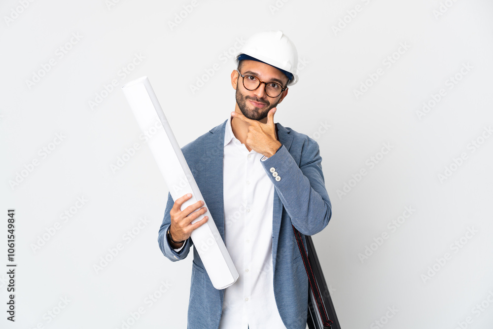 Young architect man with helmet and holding blueprints isolated on white background thinking Young architect man with helmet and holding blueprints isolated on white background thinking