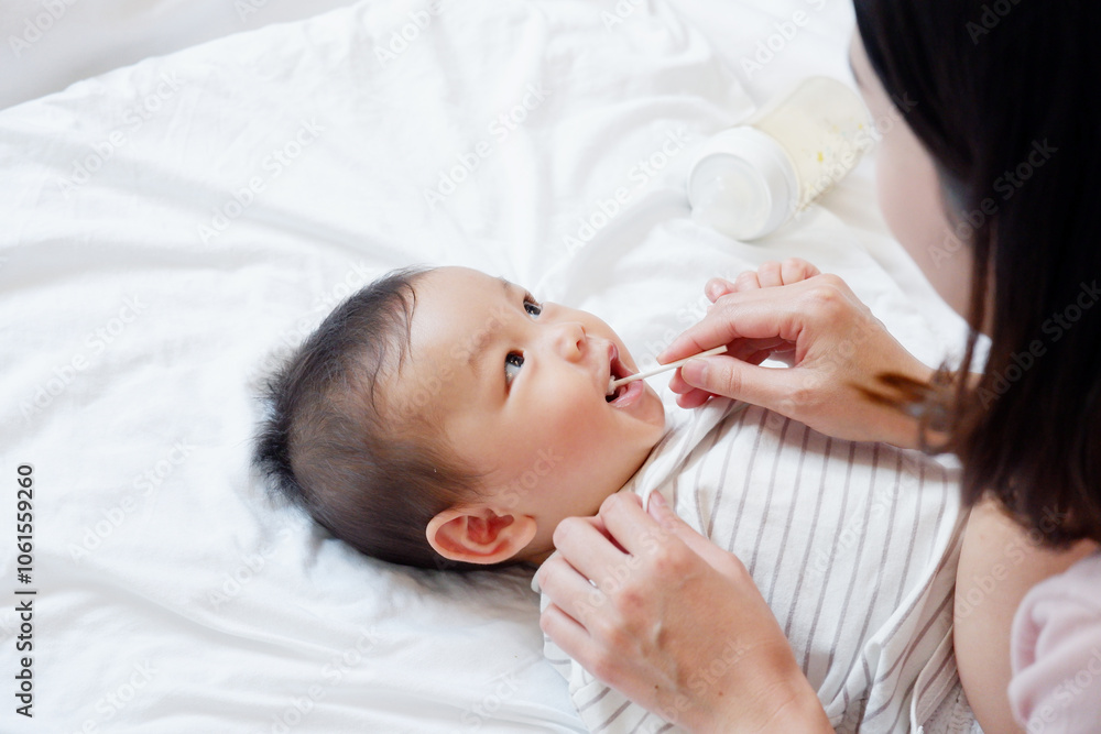 A baby or toddler is brushing his teeth and smiling. A baby or toddler is brushing his teeth and smiling.