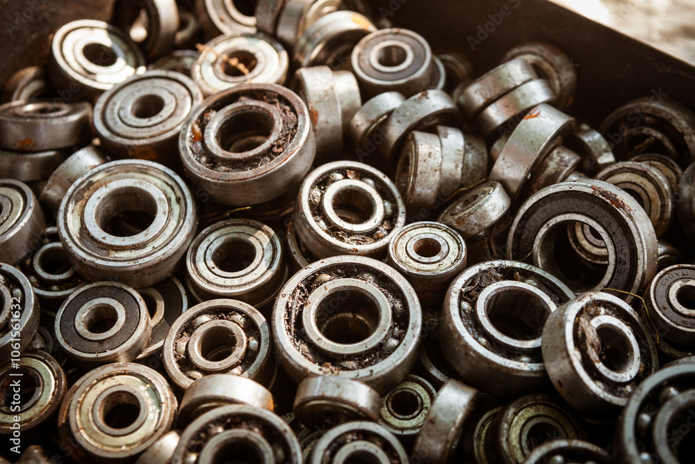 Many radial ball bearings of different sizes in a box - elements of machines and mechanisms Many radial ball bearings of different sizes in a box - elements of machines and mechanisms