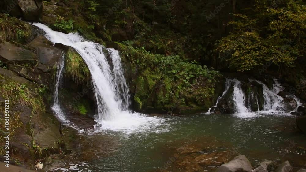 An incredibly beautiful waterfall in the middle of the mountains. An incredibly beautiful waterfall in the middle of the mountains.