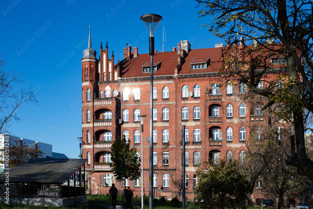 Fototapeta premium A beautiful red brick Gothic building. Ancient architecture. Living space.