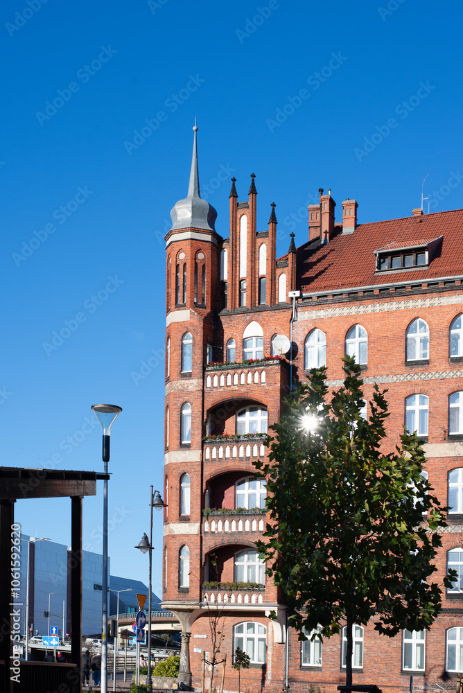 Naklejka premium A beautiful red brick Gothic building. Ancient architecture. Living space.