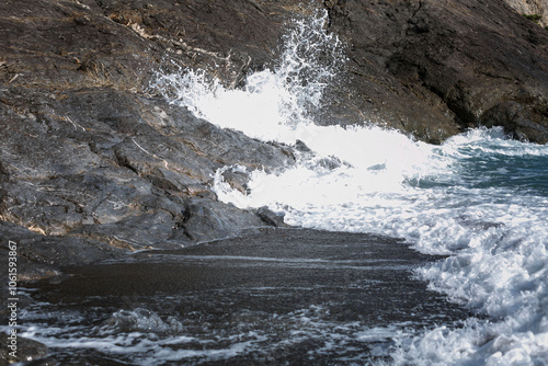 Sea foam waves beat against the rocks. Beautiful landscape. photo