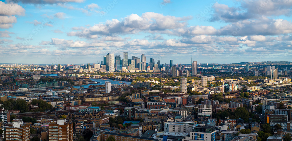 Fototapeta premium Panoramic aerial image of London cityscape with Canary Wharf skyline on the background. 