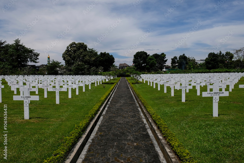 Bandung, Indonesia - January 8, 2023: Ereveld Pandu is one of 7 Netherlands war cemeteries in Indonesia where around 4000 war victims are buried. Bandung, Indonesia - January 8, 2023: Ereveld Pandu is one of 7 Netherlands war cemeteries in Indonesia where around 4000 war victims are buried.