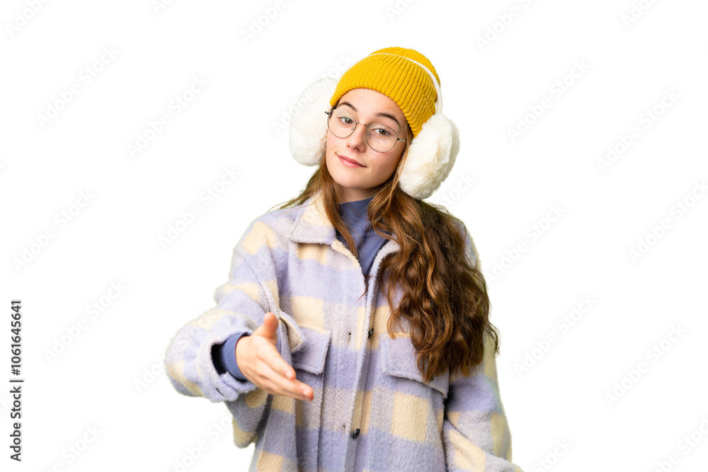 Teenager girl wearing winter muffs over isolated chroma key background shaking hands for closing a good deal Teenager girl wearing winter muffs over isolated chroma key background shaking hands for closing a good deal