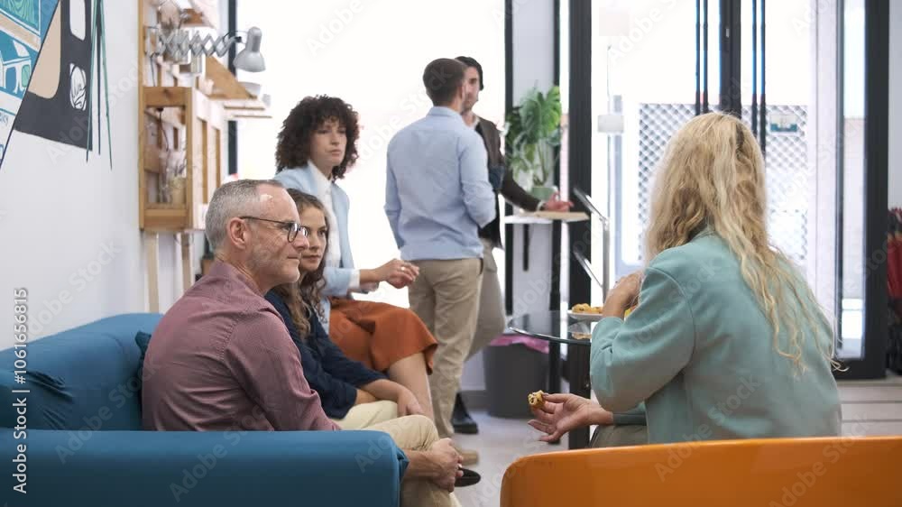 Business colleagues having conversation during break in office canteen Business colleagues having conversation during break in office canteen
