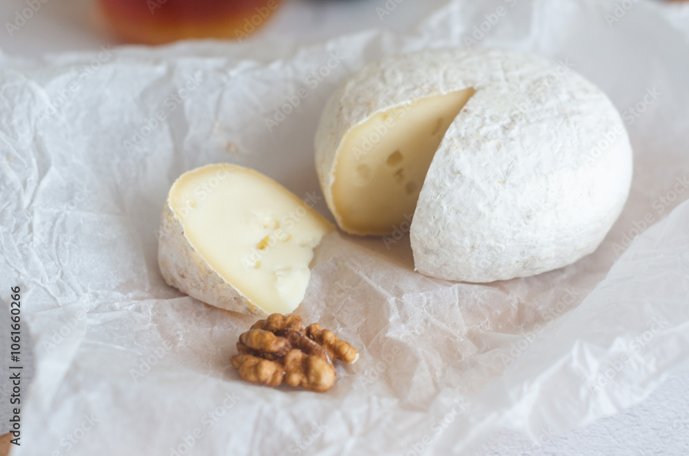 Camembert cheese with white mold, walnuts, honey and dried fruits. Dinner or aperitif concept. Camembert cheese with white mold, walnuts, honey and dried fruits. Dinner or aperitif concept.