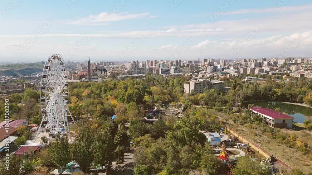Yerevan, Armenia - 19th october, 2024: Aerial panoramic view ferris wheel in Victory Park with cityscape and buildings of Yerevan. Sunny autumn day carousels day out things to do concept Yerevan, Armenia - 19th october, 2024: Aerial panoramic view ferris wheel in Victory Park with cityscape and buildings of Yerevan. Sunny autumn day carousels day out things to do concept