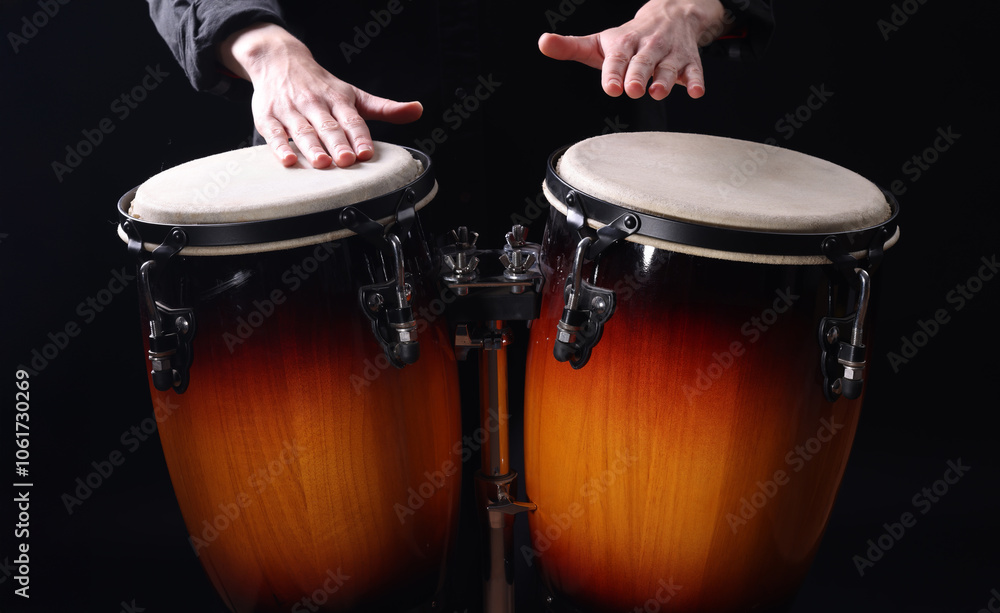 Obraz premium Drummer playing drums, different percussive musical instruments on a black background