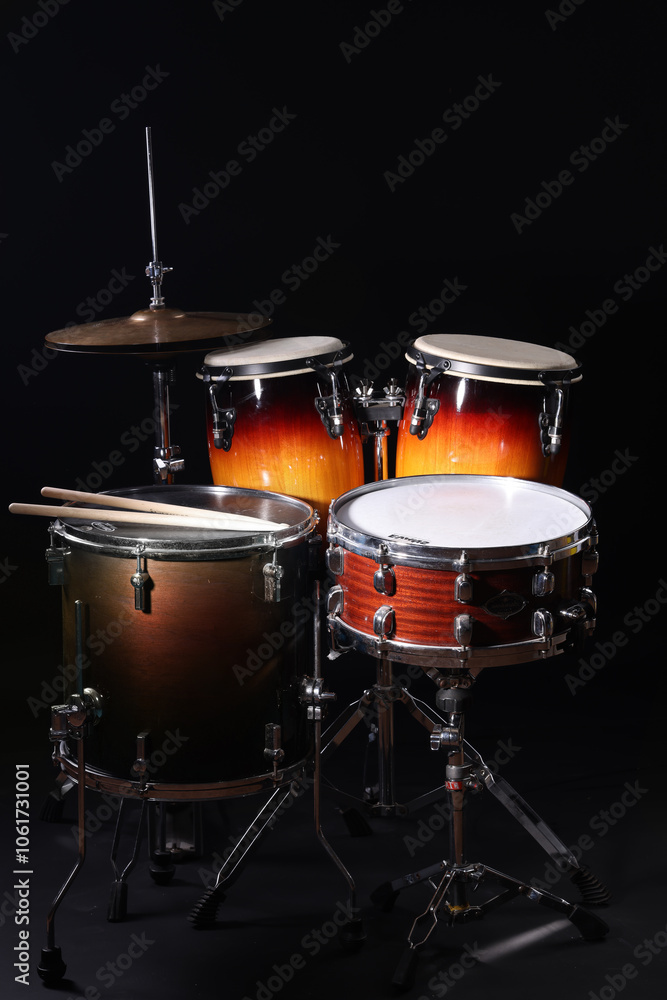 Different drums on a black background, percussion musical instruments Different drums on a black background, percussion musical instruments