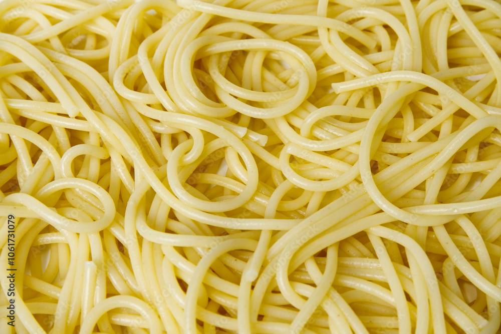 Cooked spaghetti background. Close-up spaghetti texture with concept of abstract, cooking, pasta, ingredients, eating healthy, yellow, and food culture. Food texture background of cooked spaghetti. Cooked spaghetti background. Close-up spaghetti texture with concept of abstract, cooking, pasta, ingredients, eating healthy, yellow, and food culture. Food texture background of cooked spaghetti.