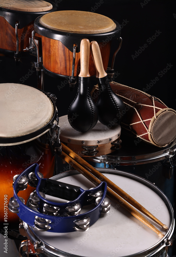 Different drums on a black background, percussion musical instruments Different drums on a black background, percussion musical instruments