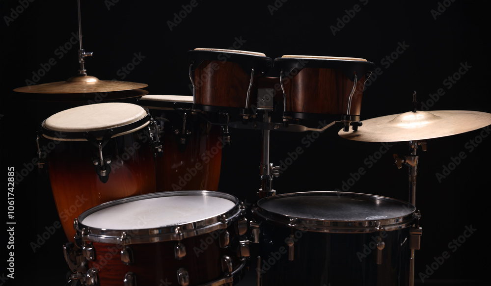 Fototapeta premium Different drums on a black background, percussion musical instruments