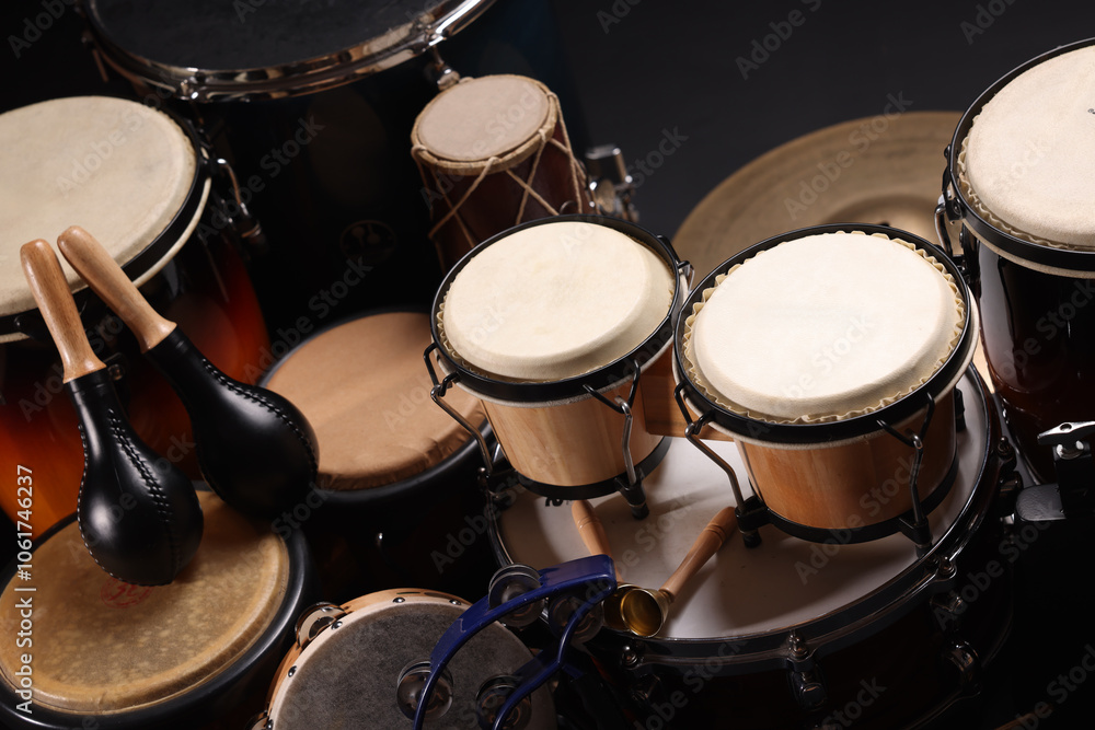 Different drums on a black background, percussion musical instruments Different drums on a black background, percussion musical instruments