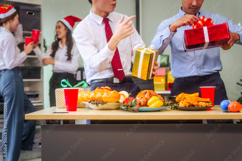 A festive office Christmas party with friends and colleagues celebrating after work. Asian business people wear Santa hats, enjoy grilled chicken, drinks, and gifts, indoor with holiday lights.