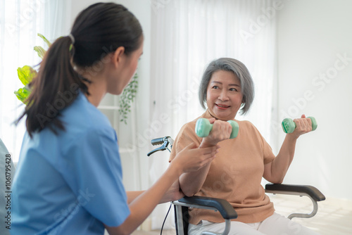 Friendly caregiver helping senior woman with dumbbell exercise at home, supporting health, wellness, and active aging. Elderly care assistance for physical therapy and trust.
