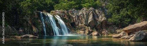 A serene view of Turner Falls Park featuring cascading waterfalls and lush greenery during a calm, sunny day