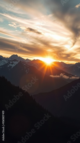 The sun sets over the mountains, casting a warm glow on the sky photo